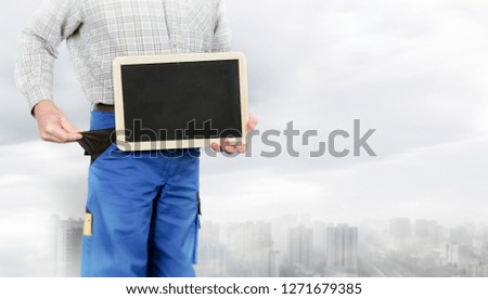 Worker holds a blackboard in hand