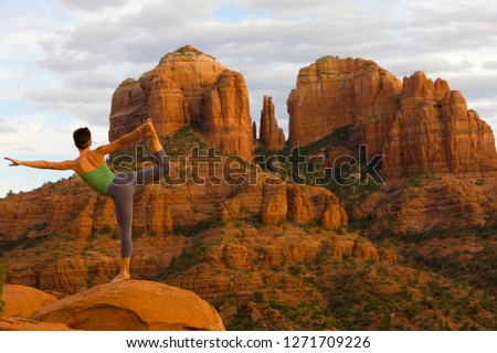 Woman alone on red rock practicing yoga in Sedona Arizona Royalty-Free Stock Photo #1271709226