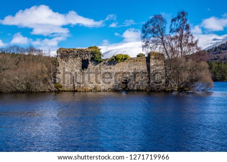 15th Century Castle at Loch an Eilean also known as Loch an Eilein near Aviemore, and Rothiemurchus Forest, Speyside, Scotland. Picture taken in April where there still was some snow on the hills. 