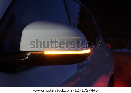 White mirror of compact SUV with turn signal