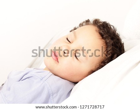 boy in bed sleeping in bed stock photo