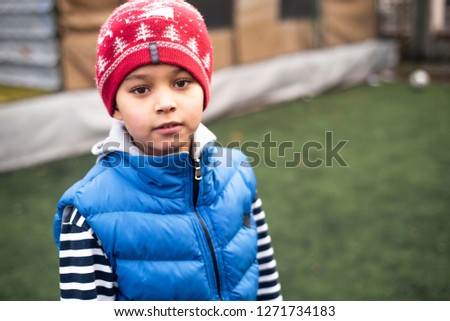 Cool african american football player boy playing football with his brother downstairs. Active mixed kids. School boys  free time. Children and sport. Brothers game. Shooting in December 2018 Istanbul