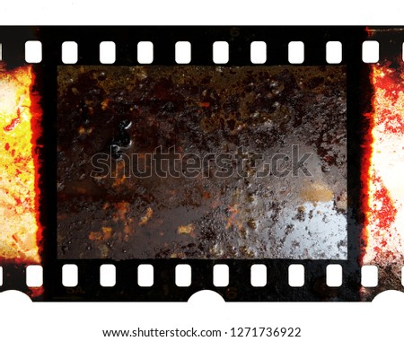 Old fashioned 35mm filmstrip or dia slide frame with burned edges isolated on white background. Real analog film scan with signs of usage. Dirty film material. 