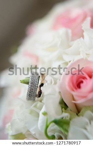 wedding rings on the background of the bride's bouquet, close-up
