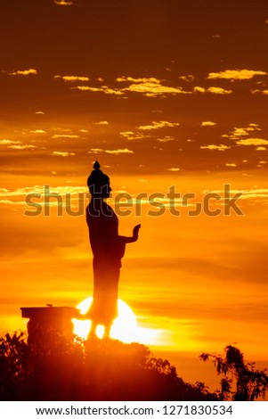 Silhouette standing Buddha statue during sunrise