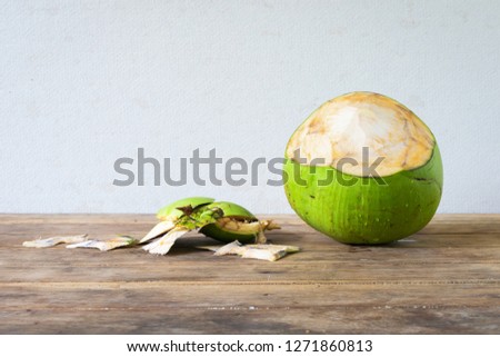 Coconut green put on old wooden desk table.