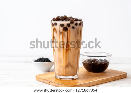 Taiwan milk tea with bubble on wood background Royalty-Free Stock Photo #1271869054