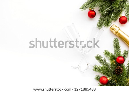 New Year celebration with spruce branch, champagne and glasses white table background top view mock up