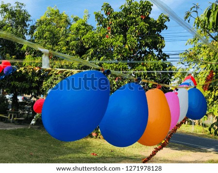 Colorful balloons hang on a rope in the party in park.