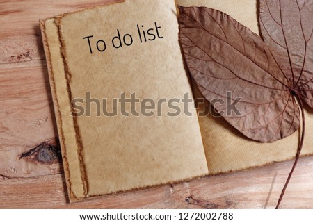 Autumn composition,autumn leaves and notebook with to do list on wood background,planning and design concept. Flat lay, top view, copy space - Image