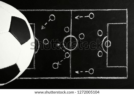 Chalkboard with football game scheme and soccer ball, top view