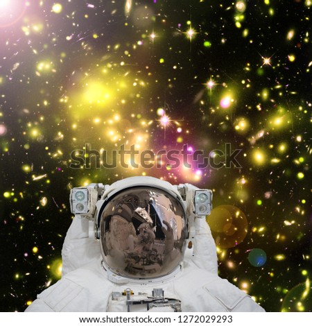 Closeup of astronaut. Galaxy on the background. The elements of this image furnished by NASA.