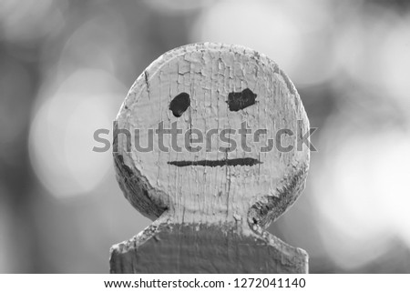 City street. Fragment of the fence. The figure of the little man with the face. Horizontal frame. Picture taken in Ukraine, Kiev region. Black and white image