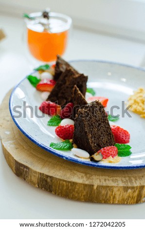 chocolate nut brownie cake decorated with strawberries. the toning. selective focus