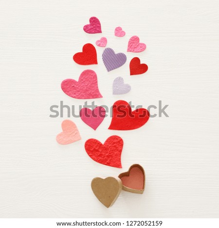 Valentine's day concept. Paper hearts over wooden white background. Flat lay