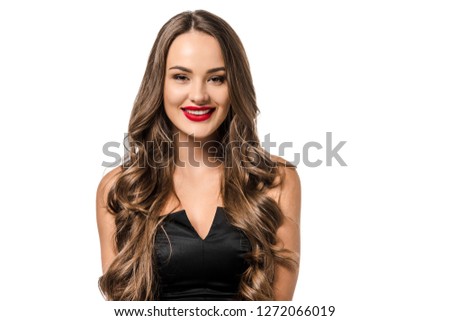 beautiful girl in black dress looking at camera and smiling isolated on white