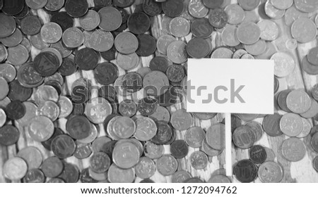 Coins in a jar on the floor. Accumulated coins on the floor. Pocket savings in piles.

