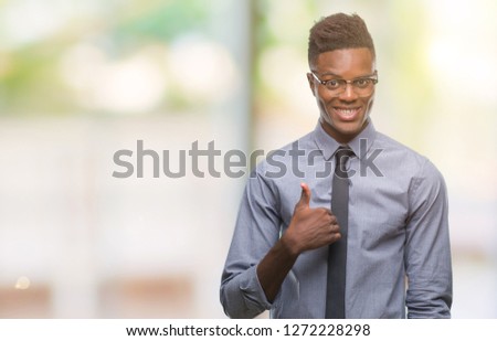 Young african american business man over isolated background doing happy thumbs up gesture with hand. Approving expression looking at the camera with showing success.