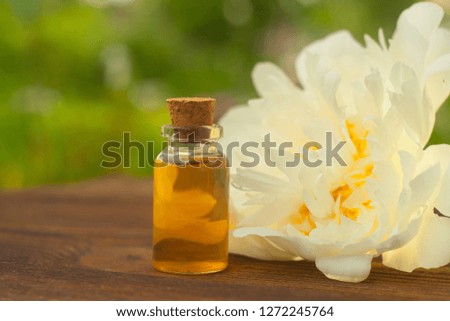 Essence of flowers on a table in a beautiful glass bottle