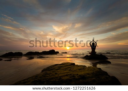 Tropical summer yoga session on beautiful sunset beach, Koh Kradan island in Thailand. Meditation - lotus pose - padma asana
