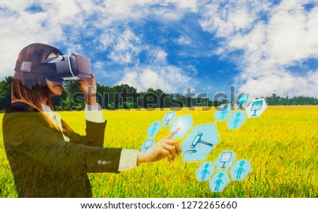 Business woman hand touch screen in auction,with icon agricultural product auctioneer,sky background and organic fields,concept offer of agricultural products and futures trading advanced technology