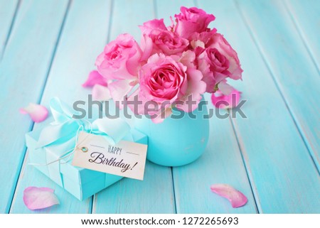 pink rose flowers in a vase and gift box. shabby chic colors. happy birthday