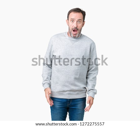 Handsome middle age senior man wearing a sweatshirt over isolated background In shock face, looking skeptical and sarcastic, surprised with open mouth