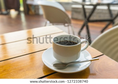 Cup of coffee on wood table.