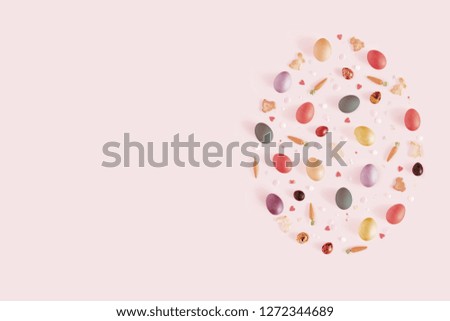 Top view and flat lay of arrangement decoration Happy Easter, holiday background concept. Colorful bunny cookies, eggs and topping ornament design as big egg on pink pastel desk with copy space.