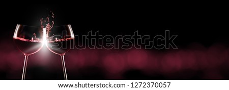 Red wine, red wine glasses toast, dark background