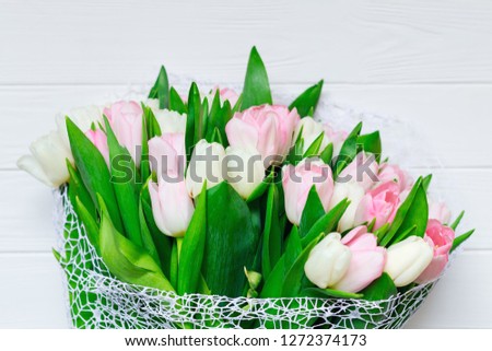 Bouquet of tulips in front of spring scene.