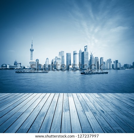 shanghai skyline and wooden floor with blue tone,beautiful scenery of the huangpu river.