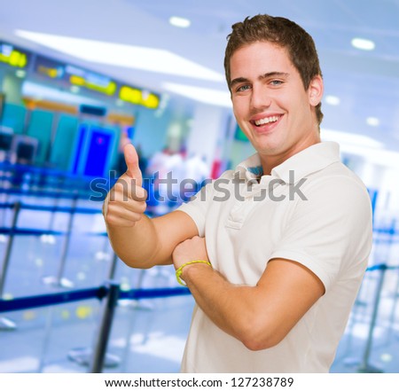 Young Man Showing Thumb Up at an airport