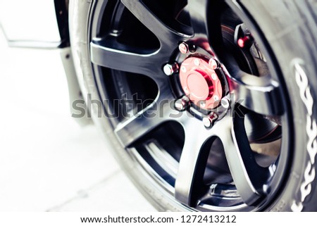 car wheels are dressed in black, trimmed with red, making them look hot spots car.