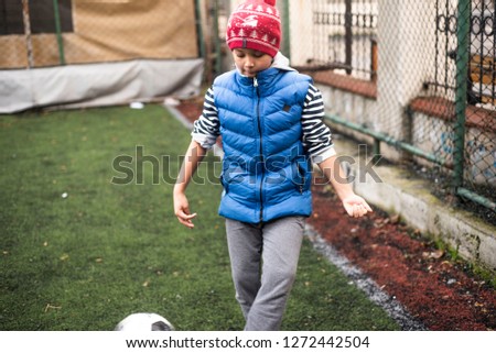 Football players kids. Boy playing football with his brother downstairs. Active mixed kids. School boys  free time. Children and sport. Brothers game. Shooting in December 2018 Istanbul