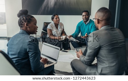 Team of african bussines people debating during a work meeting. Colleagues in serious discussions Royalty-Free Stock Photo #1272443623