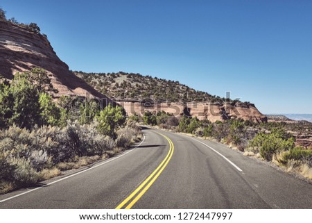 Mountain road in Colorado, retro color toned picture, USA.