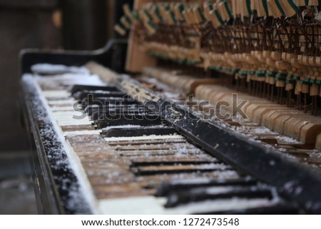 Closeup of an old broken piano in the snow