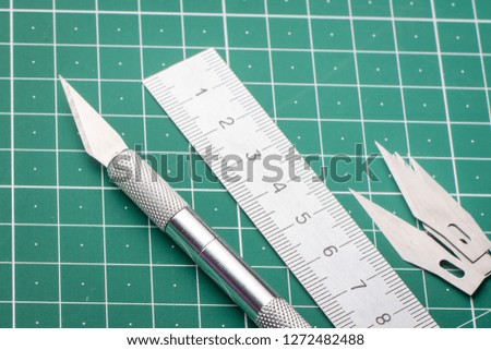 Set of new professional metal scalpel, ruler and blades on wooden table