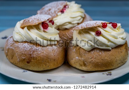 Three Semla Cakes with Cranberrys on Saucer 
