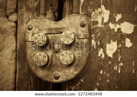 Old rural farm of peasants. On the barn hangs a lock with a code set on the numbers. Picture taken in Ukraine, Kiev region. Black and white image. Sepia