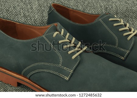 A close up of navy blue leather dress shoes for men.