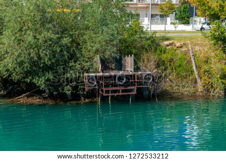 Old broken wooden pier on the shore. Photos of the coast view from the sea. The concept of summer holidays, sports, tourism