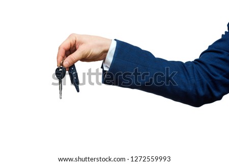 Businessman holding the car key, isolated on white background. Businessman offering a car key. Close-up of driver's hand showing key of his own automobile