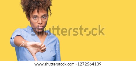 Beautiful young african american business woman over isolated background looking unhappy and angry showing rejection and negative with thumbs down gesture. Bad expression.