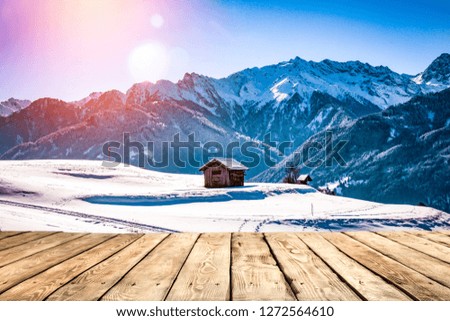 Old wooden table in the snowy mountains. Alps with a free place for an advertising product