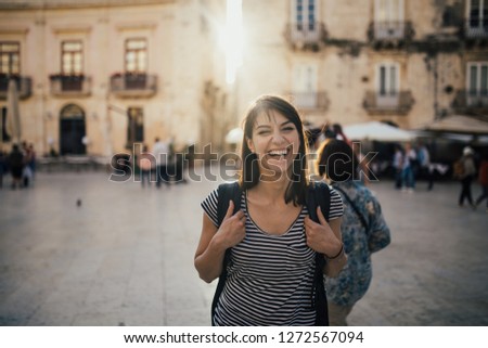 Female tourist backpacker visiting Italy.Woman in Syracuse,Sicily.Old town of Syracuse, Ortigia island visitor.Travel destination in south Italy.Italian experience.Travel photography.European trip