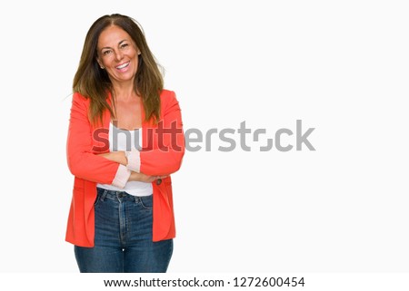 Beautiful middle age business adult woman over isolated background happy face smiling with crossed arms looking at the camera. Positive person.