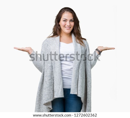 Beautiful plus size young woman wearing winter jacket over isolated background Smiling showing both hands open palms, presenting and advertising comparison and balance