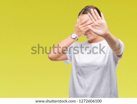 Young beautiful caucasian woman over isolated background covering eyes with hands and doing stop gesture with sad and fear expression. Embarrassed and negative concept.